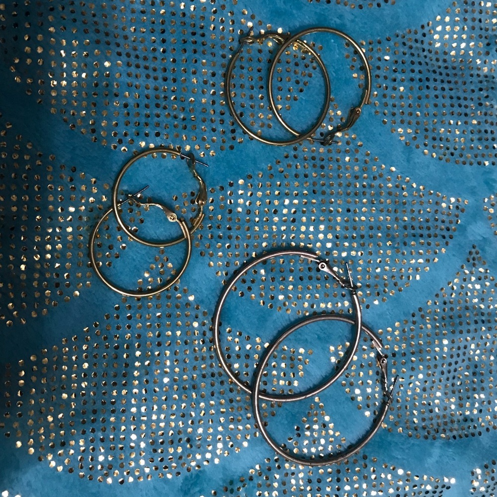 3 different sized gold metal hoop earrings